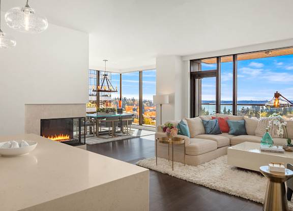a living room with a couch and a table and a fireplace at Two Lincoln Tower, Bellevue, 98004
