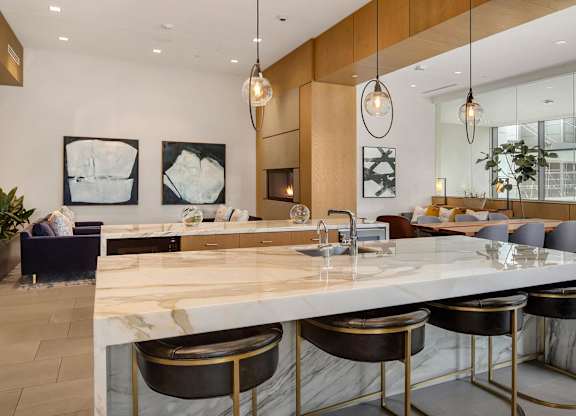the amenity space has marble counter tops and stainless steel stools at Two Lincoln Tower, Bellevue, WA