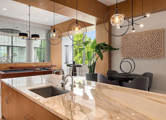 a kitchen with a marble counter top and a sink at Two Lincoln Tower, Bellevue
