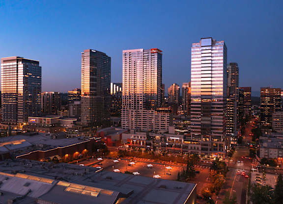 a city skyline at night with skyscrapers and a parking lot at Two Lincoln Tower, Bellevue, WA, 98004