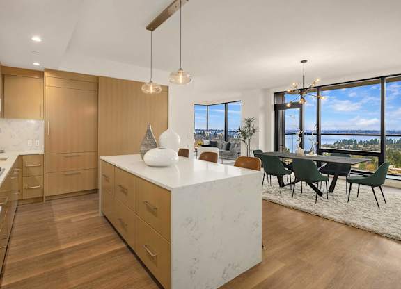 a kitchen with a large island and a table with chairs at Two Lincoln Tower, Bellevue