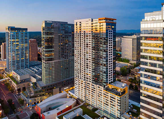 a city skyline with tall buildings at sunset at Two Lincoln Tower, Bellevue, WA, 98004
