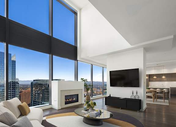 A penthouse living room with a fireplace and a view of Bellevue at Two Lincoln Tower.