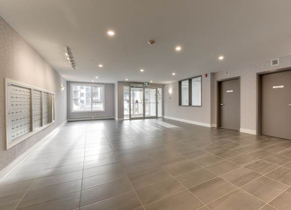 A spacious hallway with tiled floors and white walls.