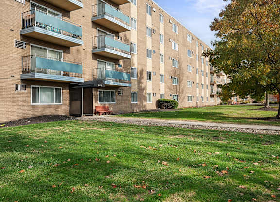 Apartment building with a tree in front.