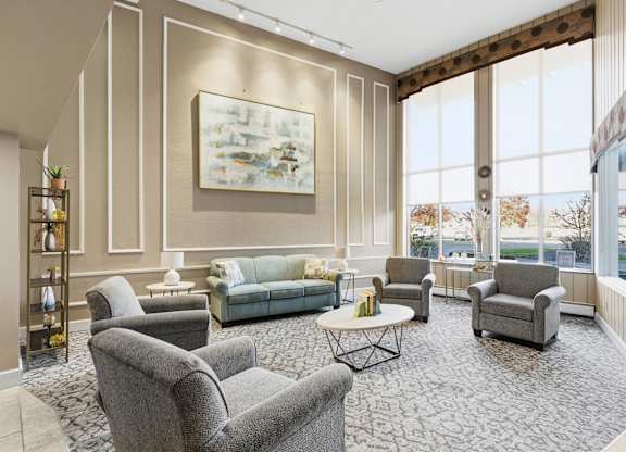 A living room with a grey sofa, two grey armchairs, a coffee table, and a painting on the wall.