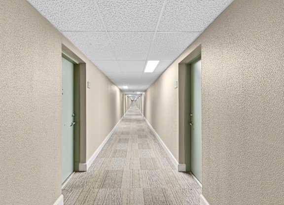 A long hallway with doors on both sides.