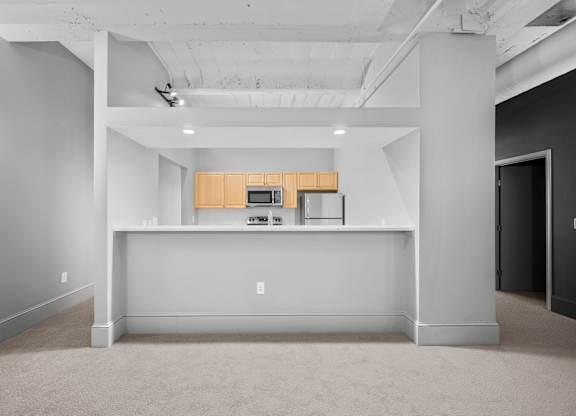 A large open space with a kitchenette in the middle.
