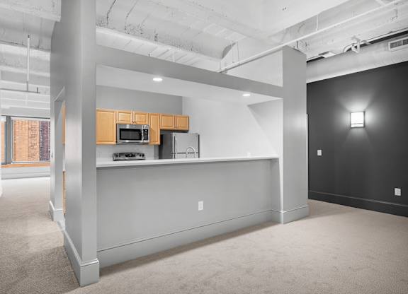A kitchen area with a microwave and oven.