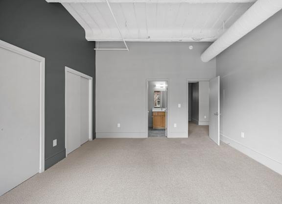 A large empty room with a door in the middle.