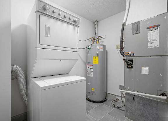 A white washing machine and dryer in a laundry room.