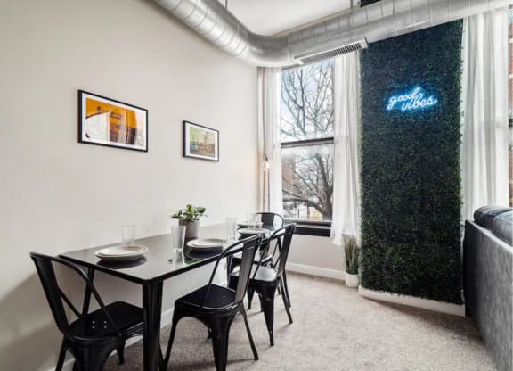 a dining room with a table and chairs and a window
