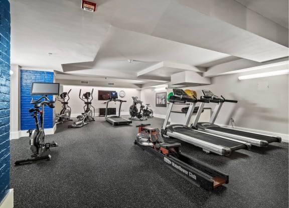 the gym has treadmills and other exercise equipment in the wellness center