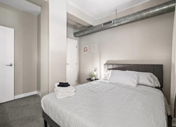 a bedroom with a large bed and a closet