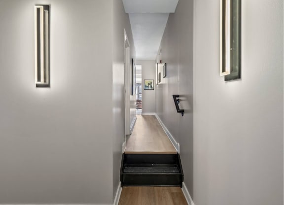 a long hallway with white walls and a long wooden counter top