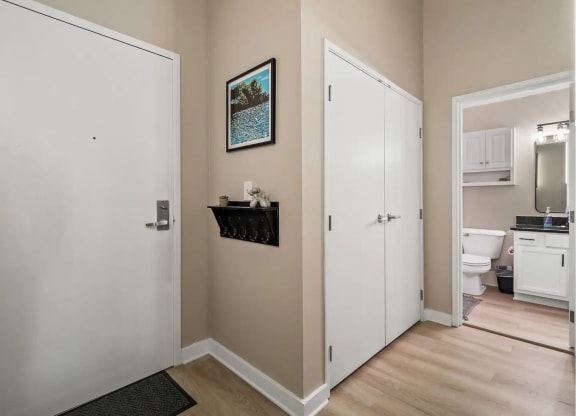 a room with a door to a bathroom and a closet