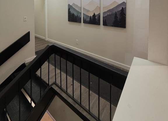 A hallway with a black railing at The Retreat at Walnut Creek, Columbus , OH, Ohio