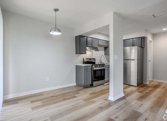 A kitchen with a refrigerator, oven, and stove. at Commons At Waters Edge, Columbus Ohio