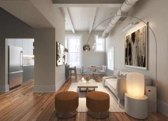 a living room with a couch and a table and a kitchen at East 4th Street, Cleveland