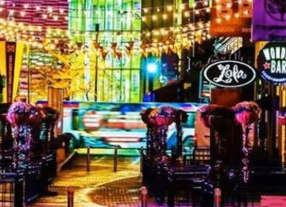 a city street filled with lots of neon signs at East 4th Street, Ohio, 44115