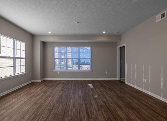 A room with wooden floors and a large window.at The Residences at Akita Lane, Canal Winchester, 43110