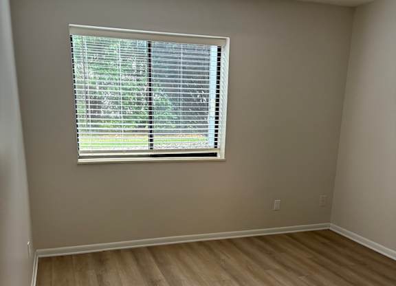 A room with a window and a wooden ceiling.