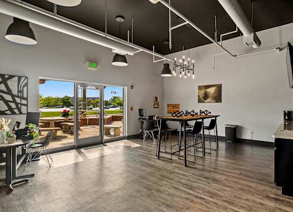 A modern kitchen with a dining table and chairs. at Vivo Toledo Apartments, Ohio, 43607