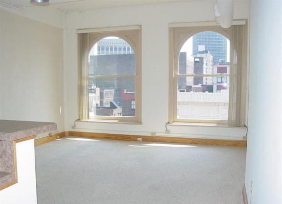 an empty room with three large windows