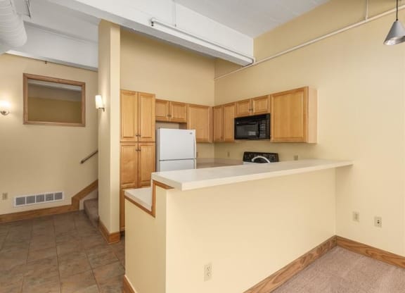 a kitchen with a counter top and a refrigerator