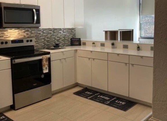 a kitchen with a stove and microwave in it