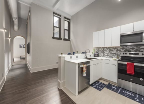 a kitchen with a stove top oven next to a sink