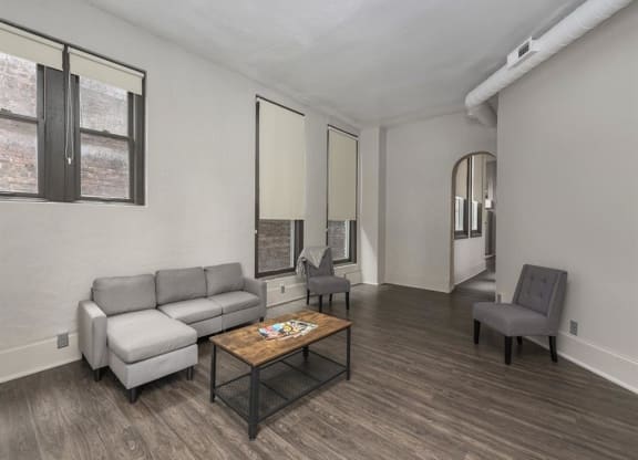 a living room with a couch chairs and a coffee table