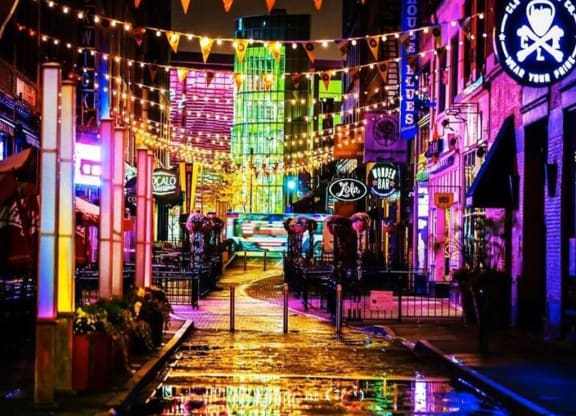 a street is lit up with colorful lights at night at East 4th Street, Cleveland, OH, 44115