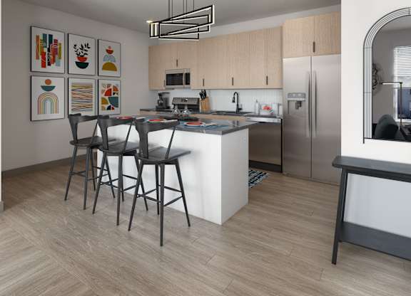 A modern kitchen with a white island and stainless steel appliances.