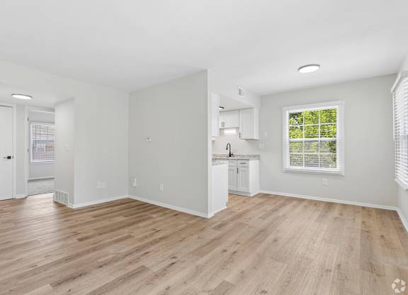 A room with wooden floors and white walls.