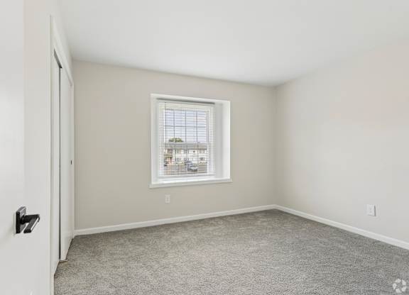 A room with a window and a door.