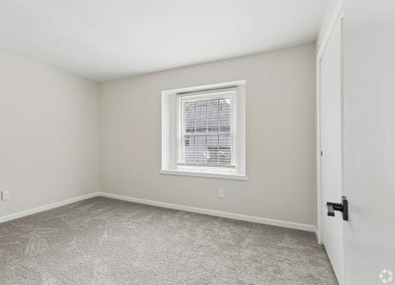 A room with a window and a door.