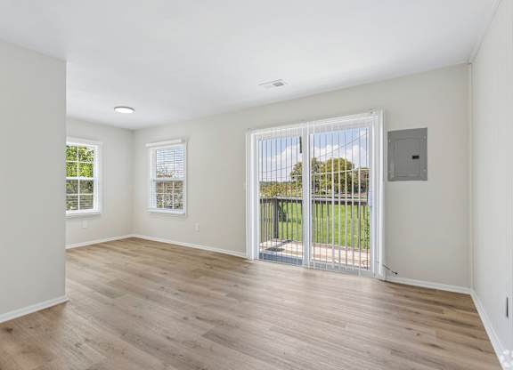A room with a sliding glass door leading to a balcony.