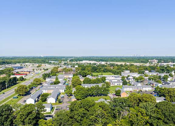 A bird's eye view of a residential area with houses and trees.