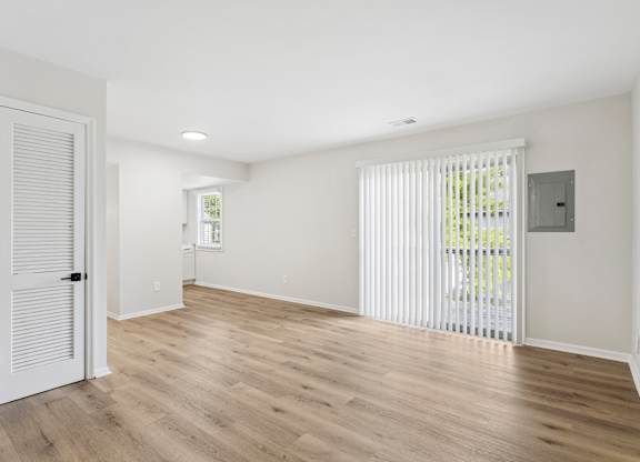 A room with wooden floors and white walls.