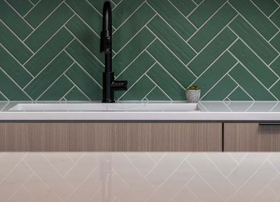 A black faucet is on a white sink at The Park Apartments, Ohio, 44113