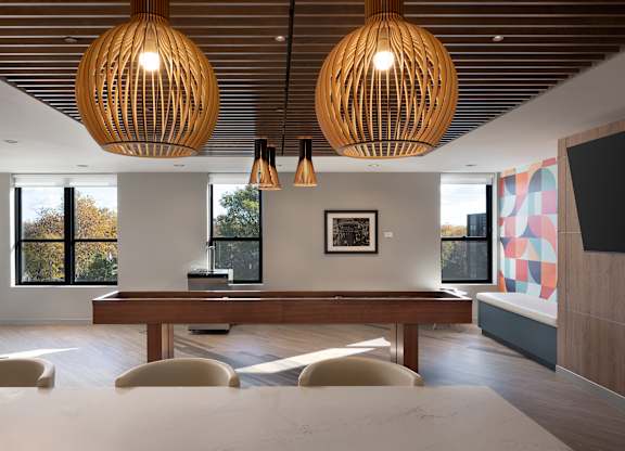 A modern dining room with a wooden table and chairs at The Park Apartments, Cleveland , OH, 44113