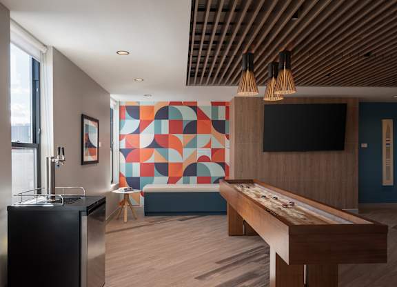 A room with a pool table and a bar at The Park Apartments, Cleveland 44113