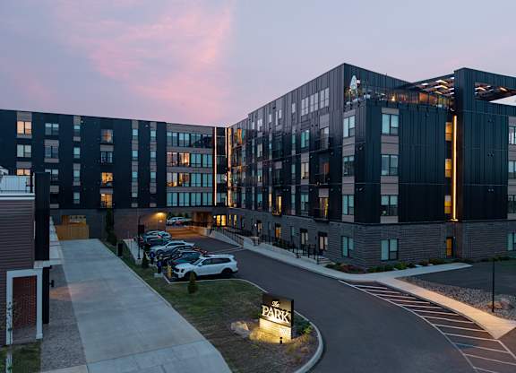 A parking lot is in front of a large building.