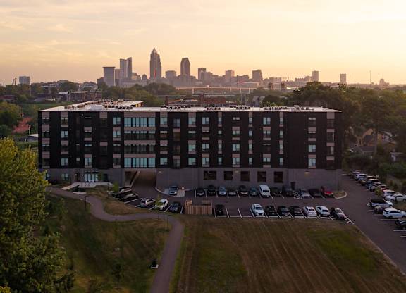 A large building with a parking lot in front of it.