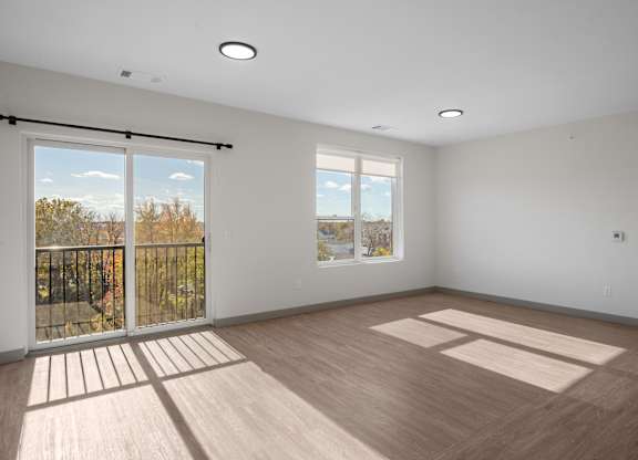 A room with a sliding glass door leading to a balcony at The Park Apartments, Cleveland , OH