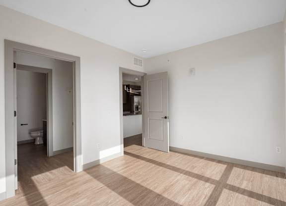 A room with a toilet and a sink visible through the open door at The Park Apartments, Cleveland , Ohio