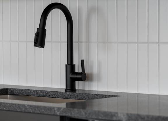 A black kitchen faucet with a pull out sprayer at The Park Apartments, Cleveland , Ohio