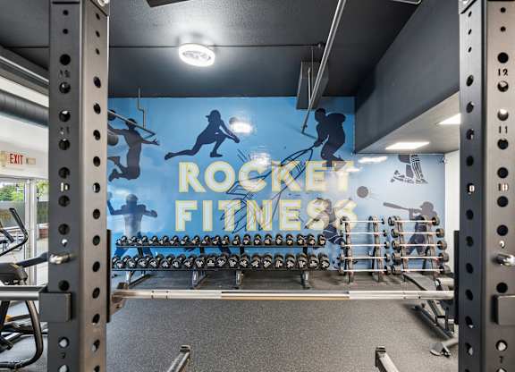 A gym with a blue wall and a sign that says