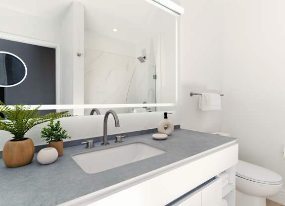 Modern bathroom with lighted mirror at Otonomus Las Vegas